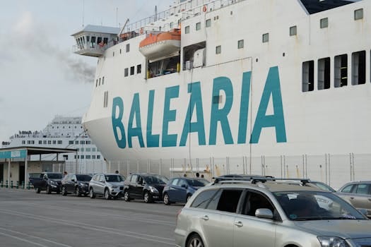 Balearia cruise ship docked at Valencia port with parked cars nearby.