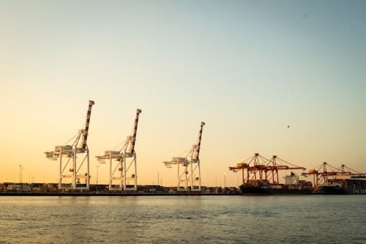 Scenic view of cargo cranes at Fremantle Port, Australia, under a sunset sky.