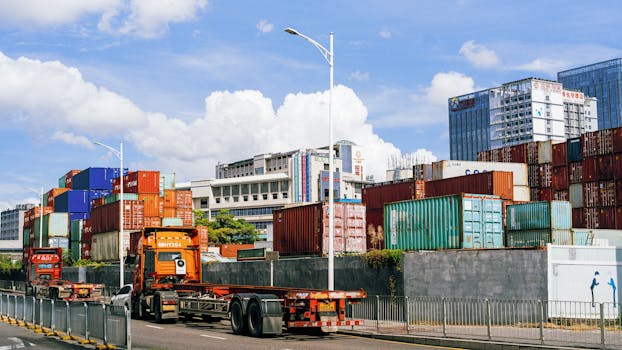 Colorful shipping containers stack at an industrial port under clear skies.