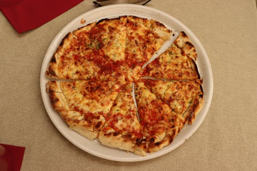Savor a freshly baked traditional pizza captured in Kotor, highlighting its cheesy, crispy perfection.