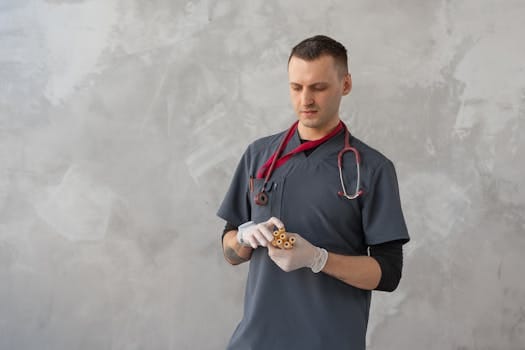 Viața la Bord în 2026: Sfaturi Esențiale, Cursuri Online de TOP și Joburi Căutate pentru Navigatori! 3 Male healthcare worker in gray scrub suit examining test tubes in a clinical setting.
