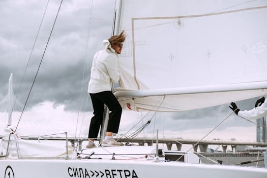 Yachtsman sailing on a breezy day with dramatic skies.