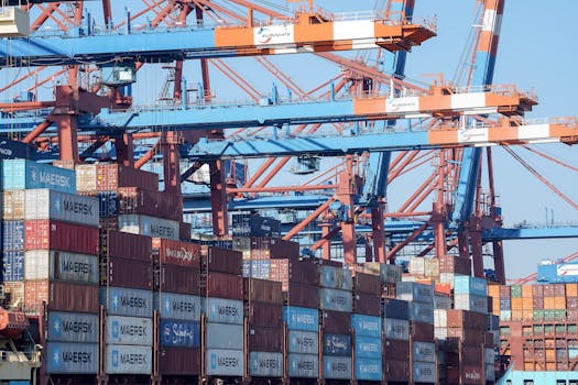 A bustling view of the Hamburg port showing cranes and stacked shipping containers.