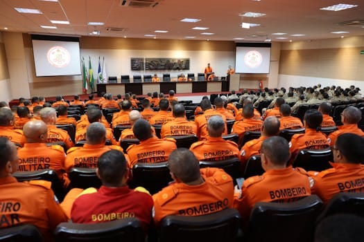 Firefighters in orange uniforms attend a strategic training session in Mato Grosso, Brazil.