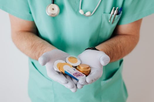 Cum să Alegi Eficient Cursul Operator GMDSS în România: Sfaturi și Costuri 2026 3 Unrecognizable medical worker demonstrating money wearing medicine form standing near white wall in hospital while working in day of salary