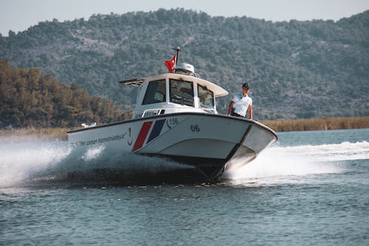Coast guard boat cruising through the water with an officer on board, showcasing maritime security.