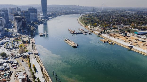 Explore the striking aerial view of Belgrade's riverfront skyline and urban landscape.