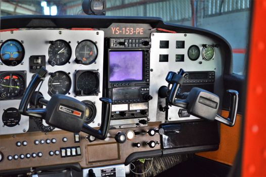 Close-up of a vintage aircraft cockpit showing detailed control panels and instruments.