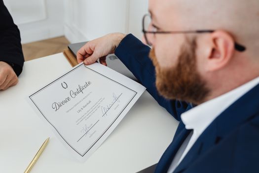 De ce Certificatul STCW nu Îți Garantează Automat Accesul la Carierele pe Mare în 2026 2 A man holding a divorce certificate in a formal office environment.