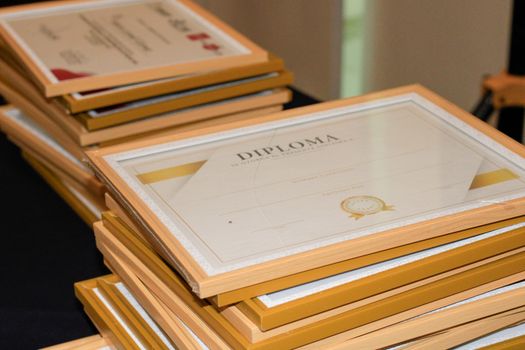 De ce Certificatul STCW nu Îți Garantează Automat Accesul la Carierele pe Mare în 2026 4 A stack of elegant framed diplomas prepared for an academic ceremony.