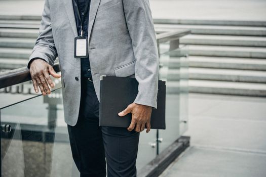 Top 5 Aspecte de Luat în Considerare la Scrierea unei Scrisori de Intenție pentru o Carieră Maritimă 3 Crop unrecognizable African American entrepreneur leaning on fence and carrying folder with papers in soft daylight