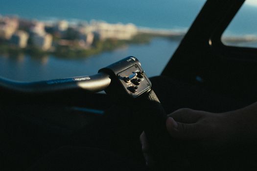 Top 7 Companii de Shipping din România care Revoluționează Formarea Profesională pentru Certificările STCW 4 A person's hand gripping an aircraft control inside a cockpit during daytime.