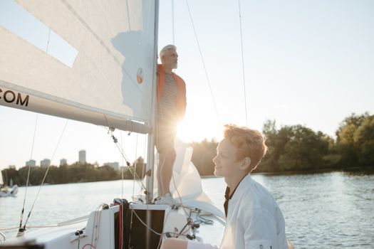 Top 7 Elemente Esențiale pentru o Scrisoare de Intenție de Succes în Shipping 3 Grandfather and grandson enjoying a leisurely sailing day under the sun.